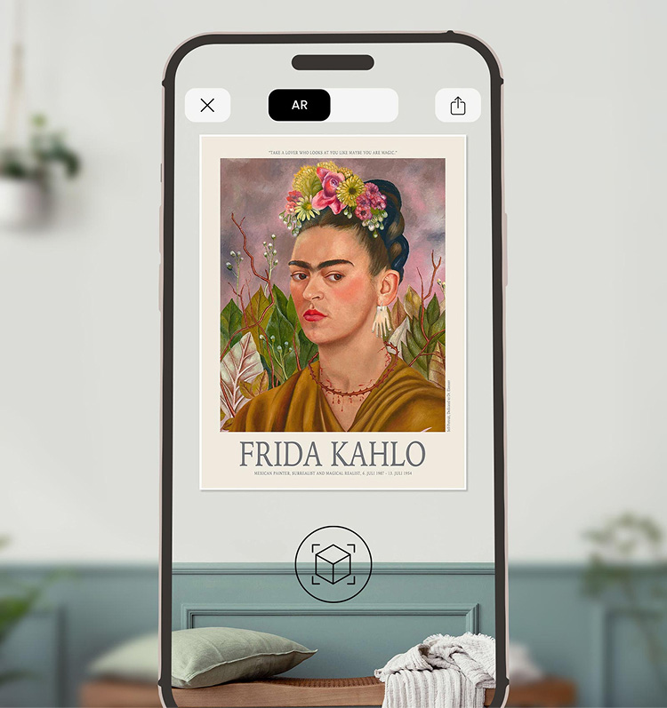 Smartphone displaying an AR preview of a Frida Kahlo poster in a living room