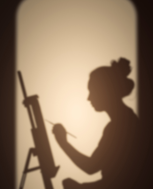 Shadow of a woman painting on a canvas