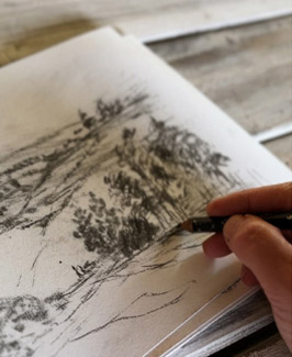 Dan Hobday sketching a landscape scene